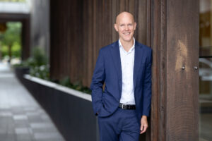 Andrew Rich in an open blazer smiling